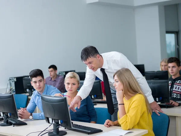 Students with teacher in computer lab classroom