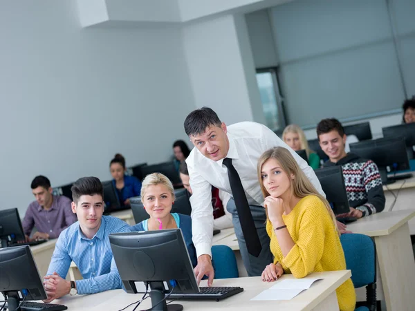 Students with teacher  in computer lab classroom