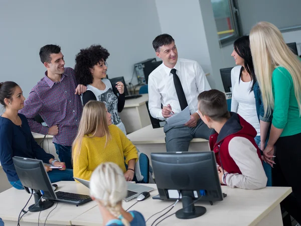 Students with teacher  in computer lab classroom