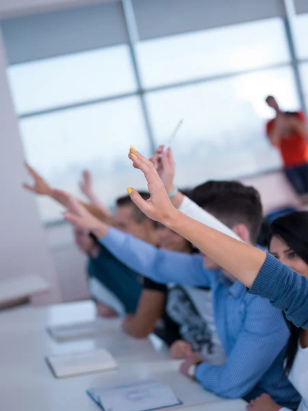 Group of Students raise their hands up