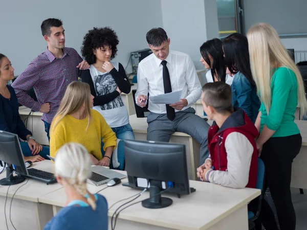 Students with teacher  in computer lab classroom