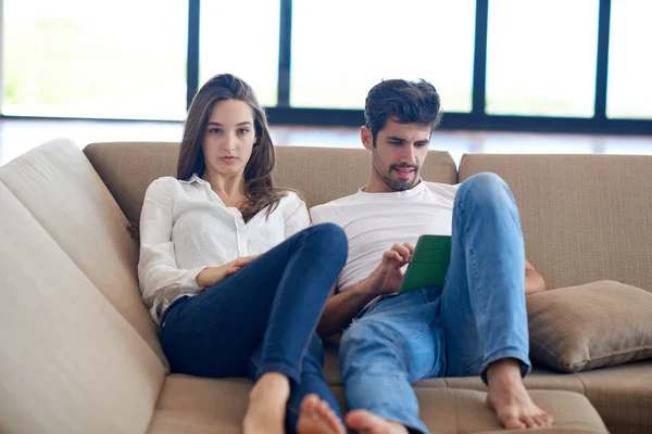 Couple at modern home using tablet computer