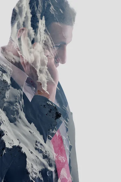 Double exposure of  business man with  mobile phone and mountain