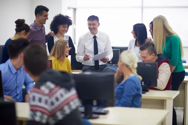 Students with teacher in computer classroom