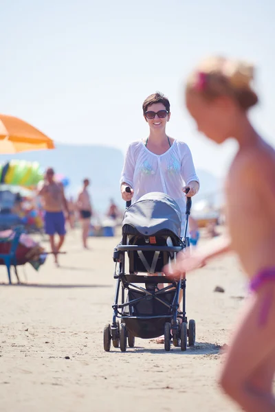 Mother walking with baby carriage