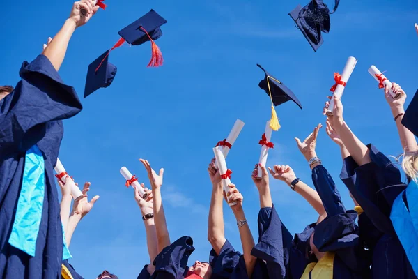 High school graduates tossing up hats