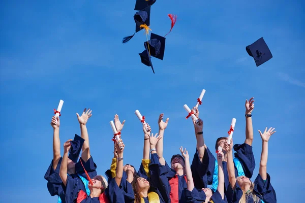 High school graduates tossing up hats