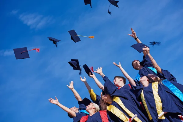 High school graduates tossing up hats