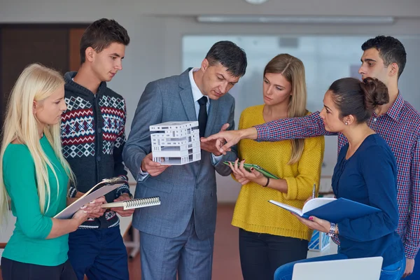 Group of students working with teacher