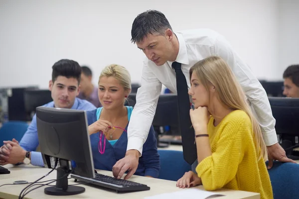 Students with teacher  in computer lab classroom