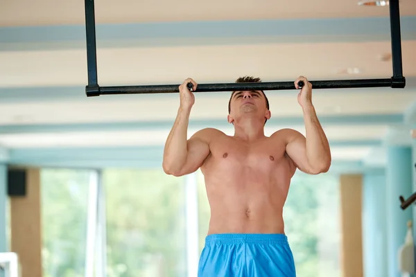 Young man working out in gym