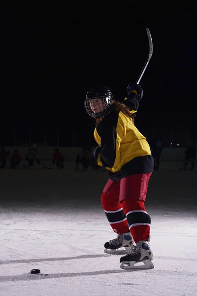 Teen ice hockey player in action
