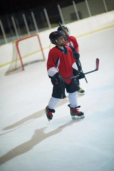 Children ice hockey player on bench