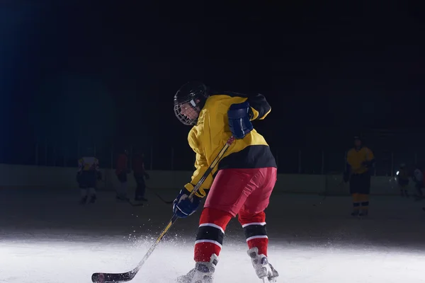 Teen ice hockey player in action