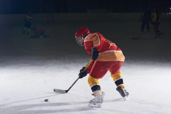 Teen ice hockey player in action