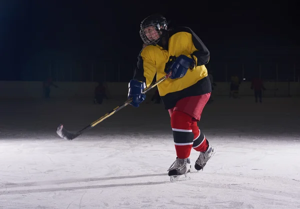 Teen ice hockey player in action