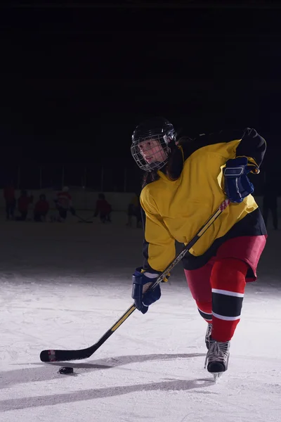 Teen ice hockey player in action