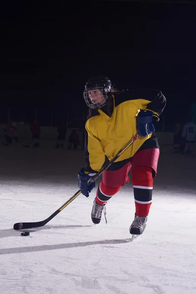 Teen ice hockey player in action