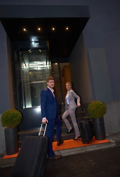 Business people couple entering  hotel
