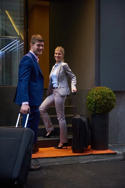 Business people couple entering  hotel