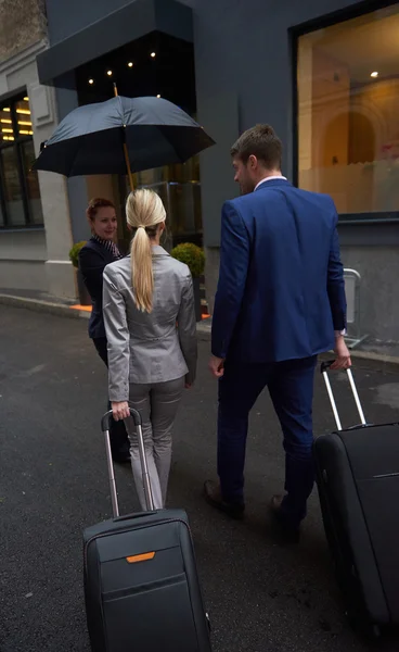 Business people couple entering  hotel