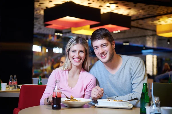 Couple having lunch break in shopping mall