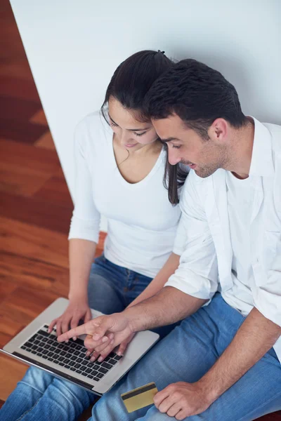 Relaxed young couple working on laptop computer