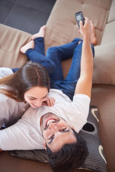 Young couple watching tv at home