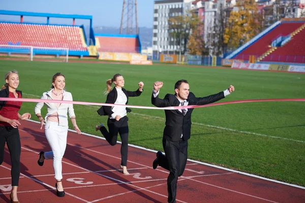 Business people running on racing track