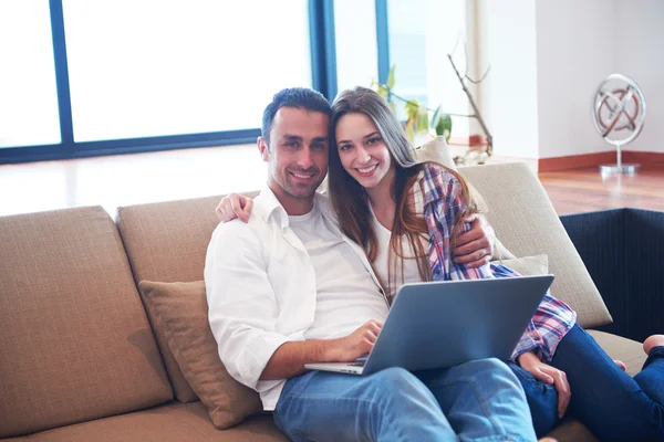 Relaxed young couple working on laptop