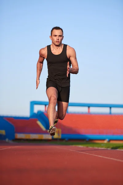 Athletic man start on track