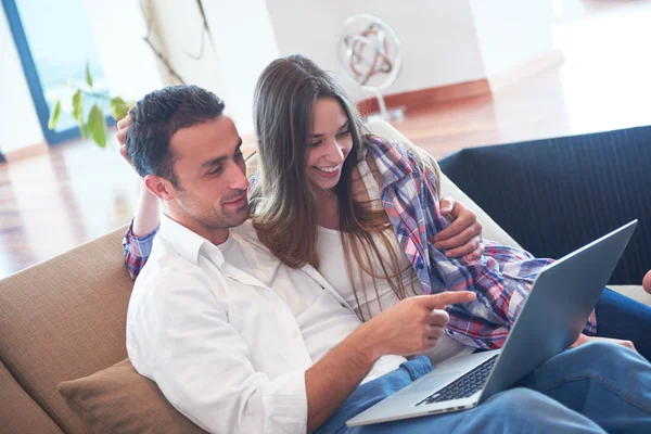 Relaxed young couple working on laptop