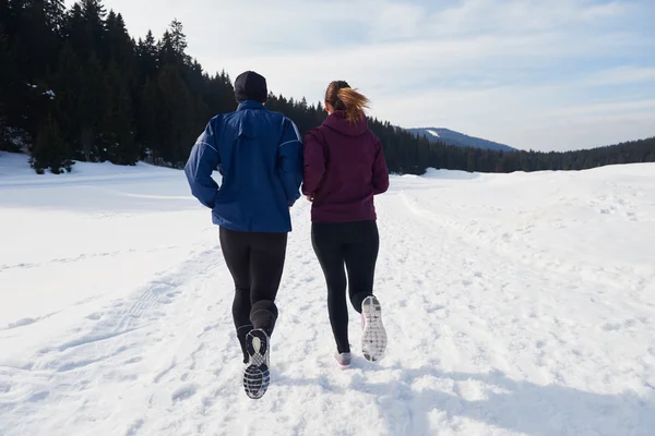 Couple jogging outside on snow