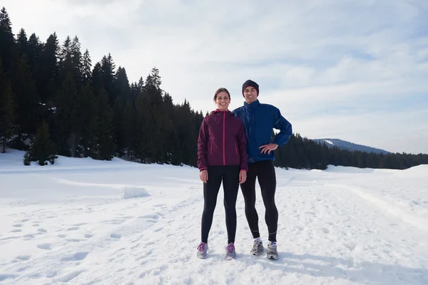 Couple jogging outside on snow