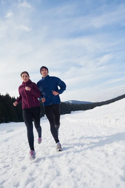 Couple jogging outside on snow