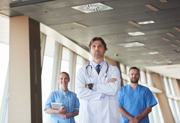 Group of medical staff at hospital, handsome doctor in front