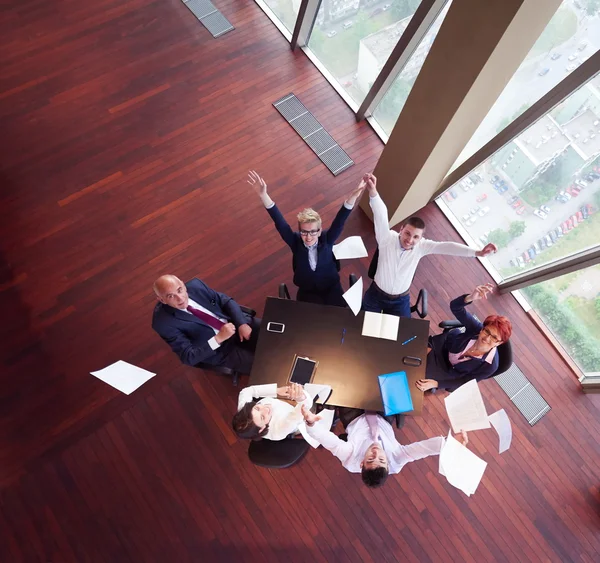 Top view of business people group throwing dociments in air