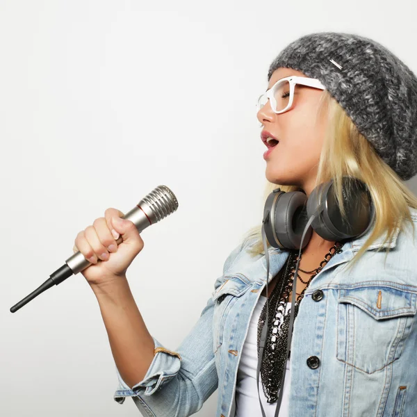 Beautiful young woman with microphone and headphones