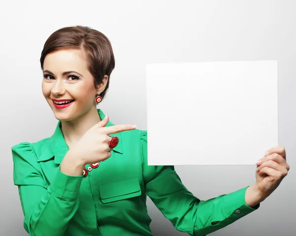 Young casual woman happy holding blank sign