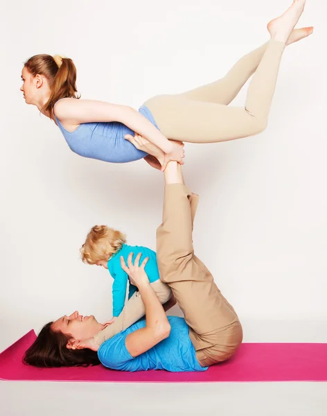Mother, father and son doing yoga