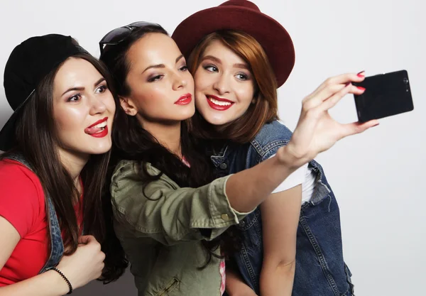 Hipster girls best friends taking selfie