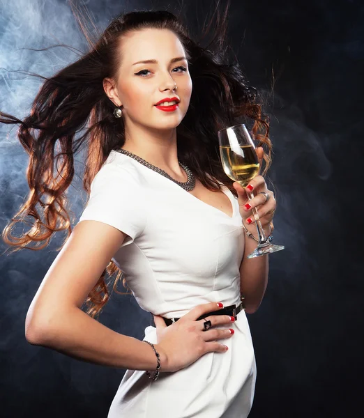 Woman in evening dress with glass of sparkling wine