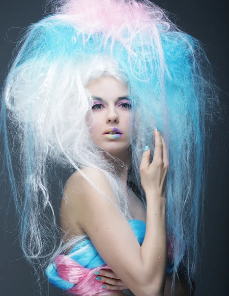Fashion model with bright make up and colorful hair