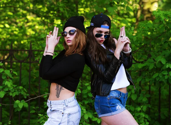 Two young hipster girl friends together having fun.