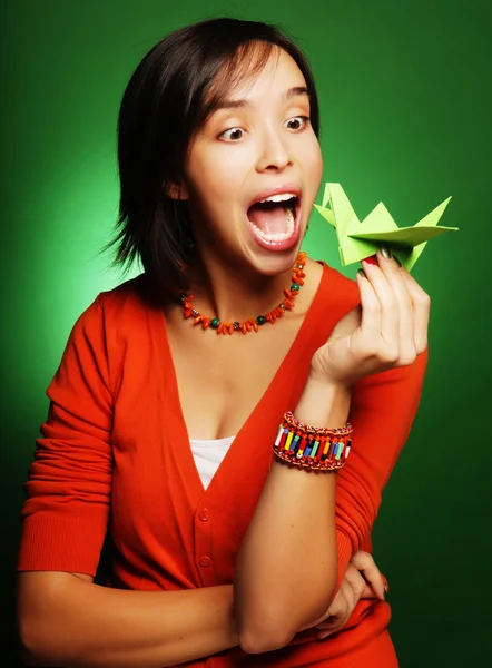 Young expression woman with paper bird