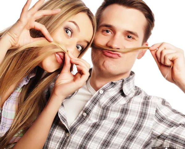Young couple making fake moustache from hair
