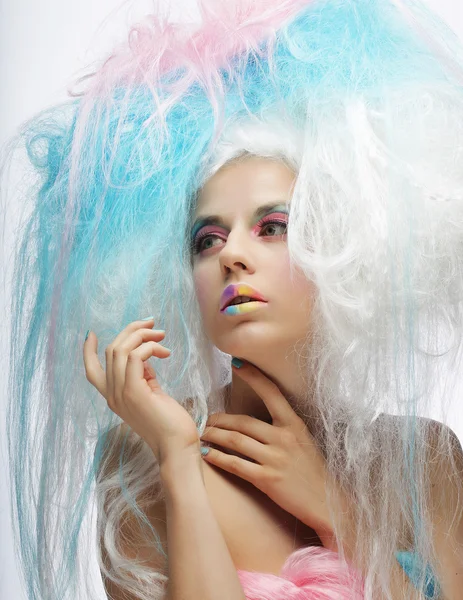 Fashion model with bright make up and colorful hair