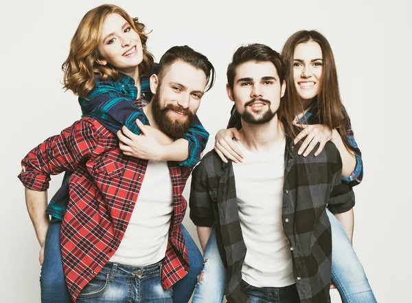 Group Of Young People Giving Piggybacks