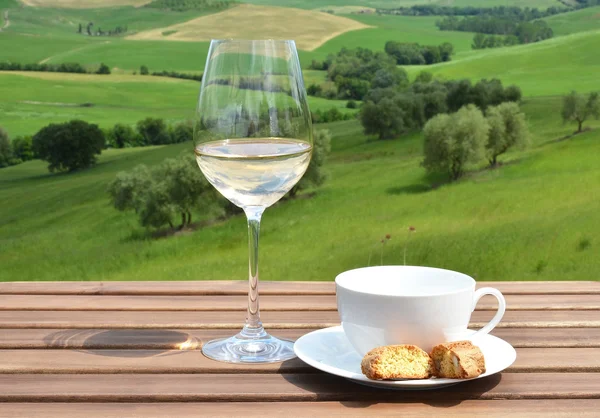 Coffee cup, cantuccini and white wine