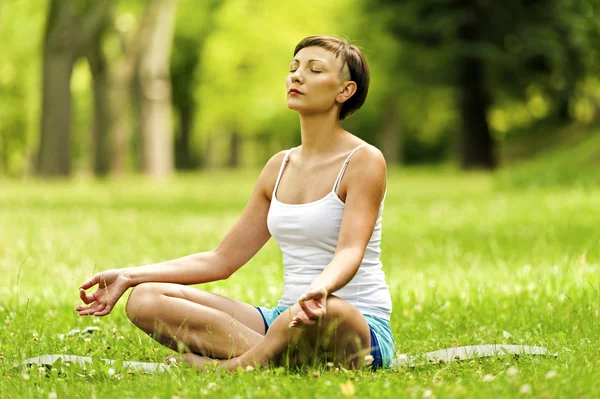 Yoga woman in lotos position with closed eyes.